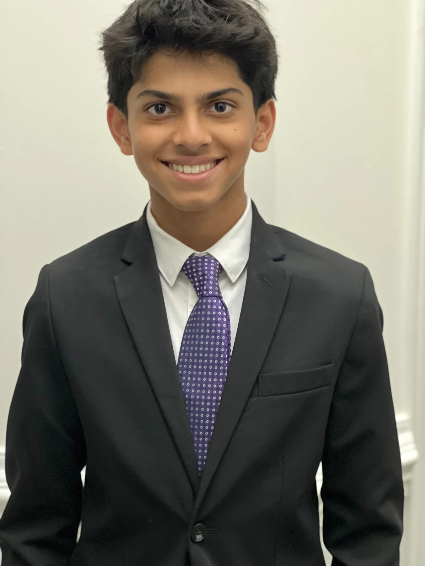 Kavin Gurunathamoorthy in a suit and purple tie